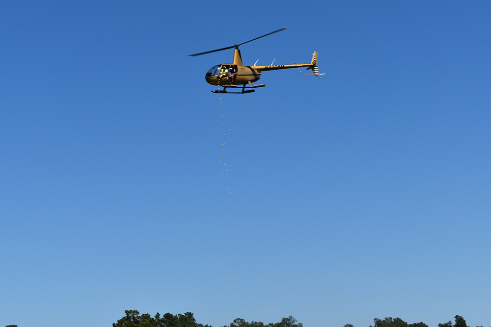 Milton Ruben Toyota General Manager Chuck Easters (yellow shirt) participates in the Helicopter Golf Ball Drop during the 2nd Annual Charity Golf Tournament benefitting fotas (Friends of the Animal Shelter) and the Aiken Animal Shelter at Houndslake Country Club. The helicopter dropped 1,000 golf balls over a designated hole, and the first ball in the hole won its owner $1,000. For more information, visit http://bit.ly/1DM1LT9.