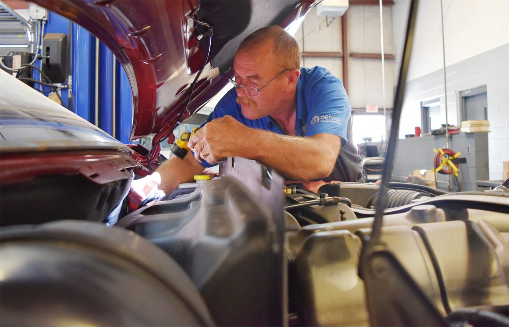 Certified Technician Dennis Miller repairs the air conditioning in a 2013 Dodge Durango. #WhatsInTheBay